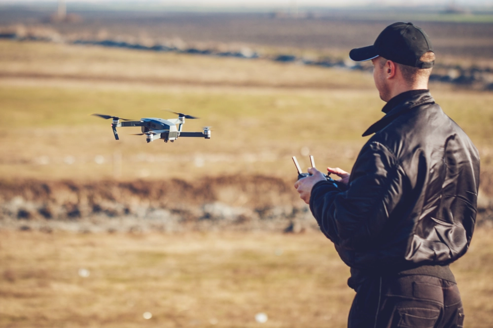 Operator flying a videography drone outdoors